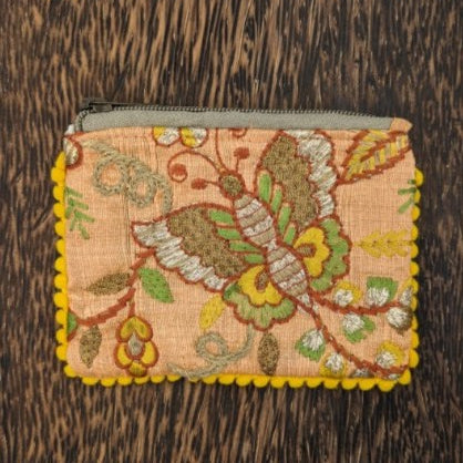 A Peach Bird and Butterfly Embroidered Bag with a zippered closure