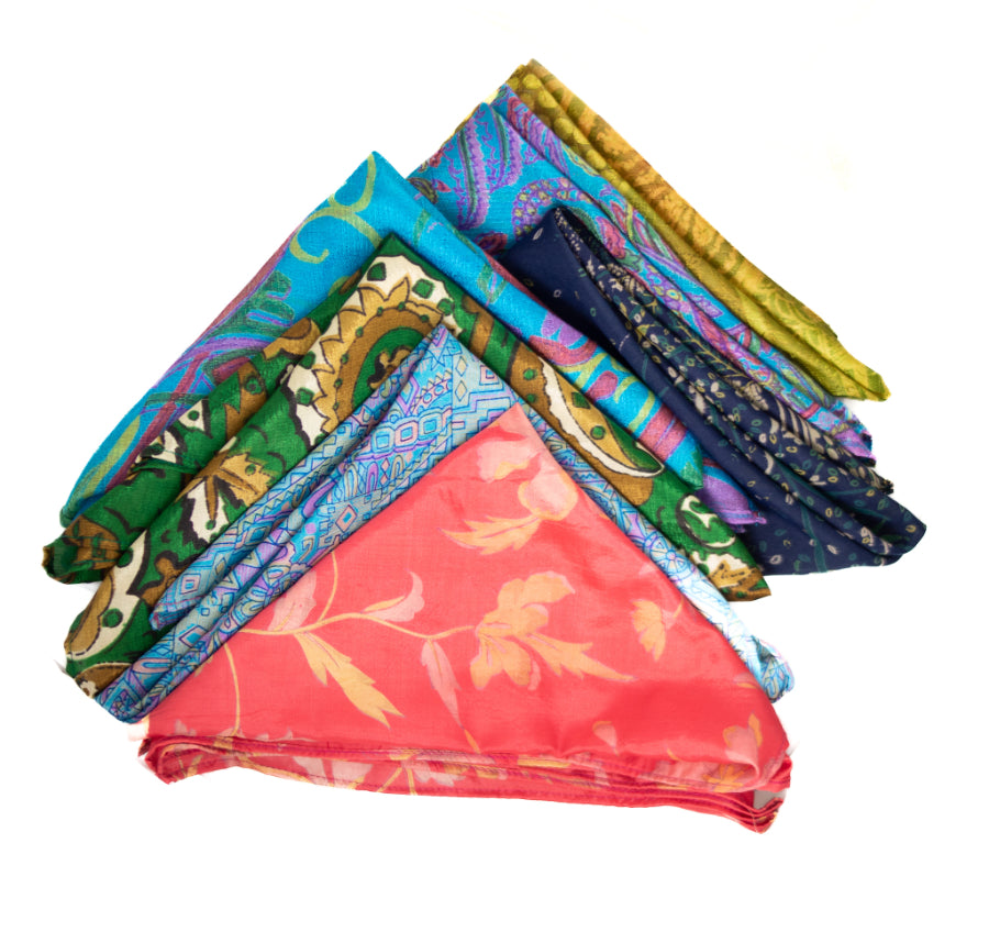 Stack of colorful patterned scarves on a white background