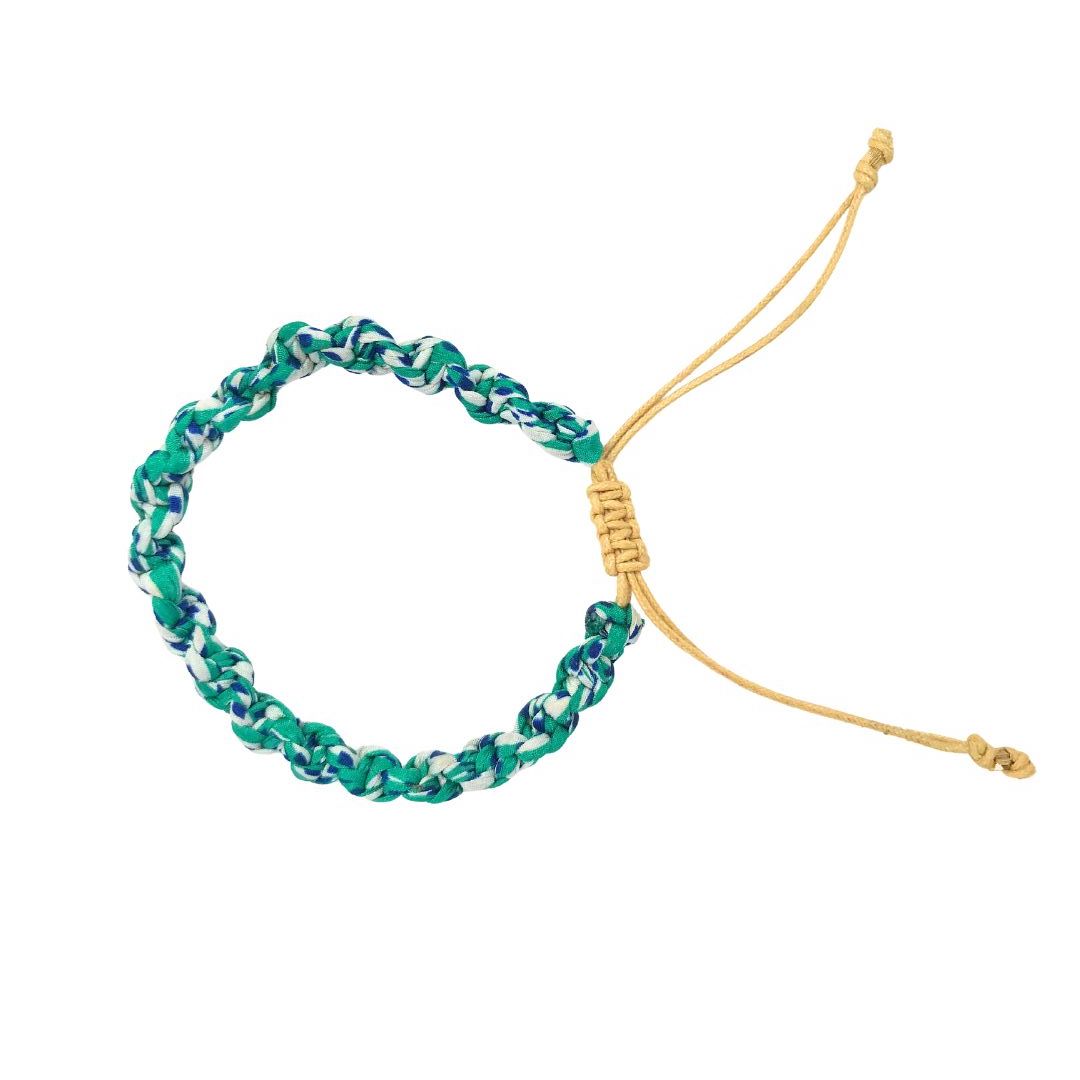 A green and gold handmade bracelet on a white background