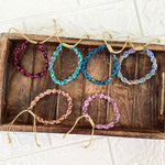 Load image into Gallery viewer, Six brightly colored bracelets on a wooden tray with a white background
