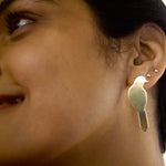 Load image into Gallery viewer, Close-up of a person wearing a gold bird-shaped earring.
