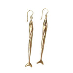 Load image into Gallery viewer, Long, slender gold toned, fish-shaped earrings on a white background
