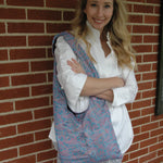 Load image into Gallery viewer, Woman with a colorful patterned tote bag on her shoulder against a brick wall
