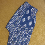 Load image into Gallery viewer, Blue and white patterned pants on a beige surface
