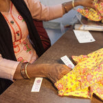 Load image into Gallery viewer, Person wearing a floral outfit packaging yellow floral children's pants
