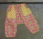 Load image into Gallery viewer, Floral-patterned baby pants on a textured surface

