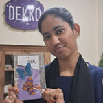 Load image into Gallery viewer, Artisan lady holding a DEKKO product package in front of a DEKKO branded wall.
