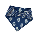 Load image into Gallery viewer, Blue bib with white floral patterns on a white background
